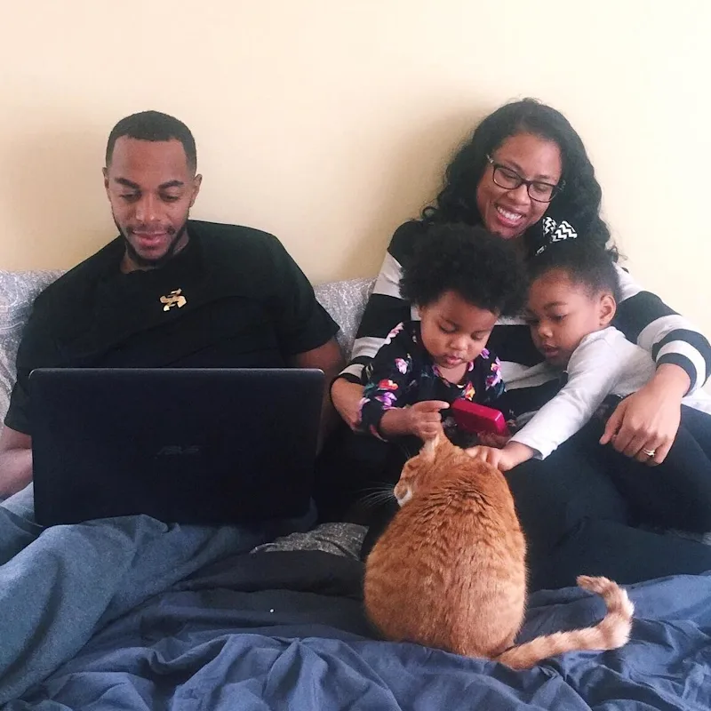 Family sitting down on the computer reviewing joint trusts.