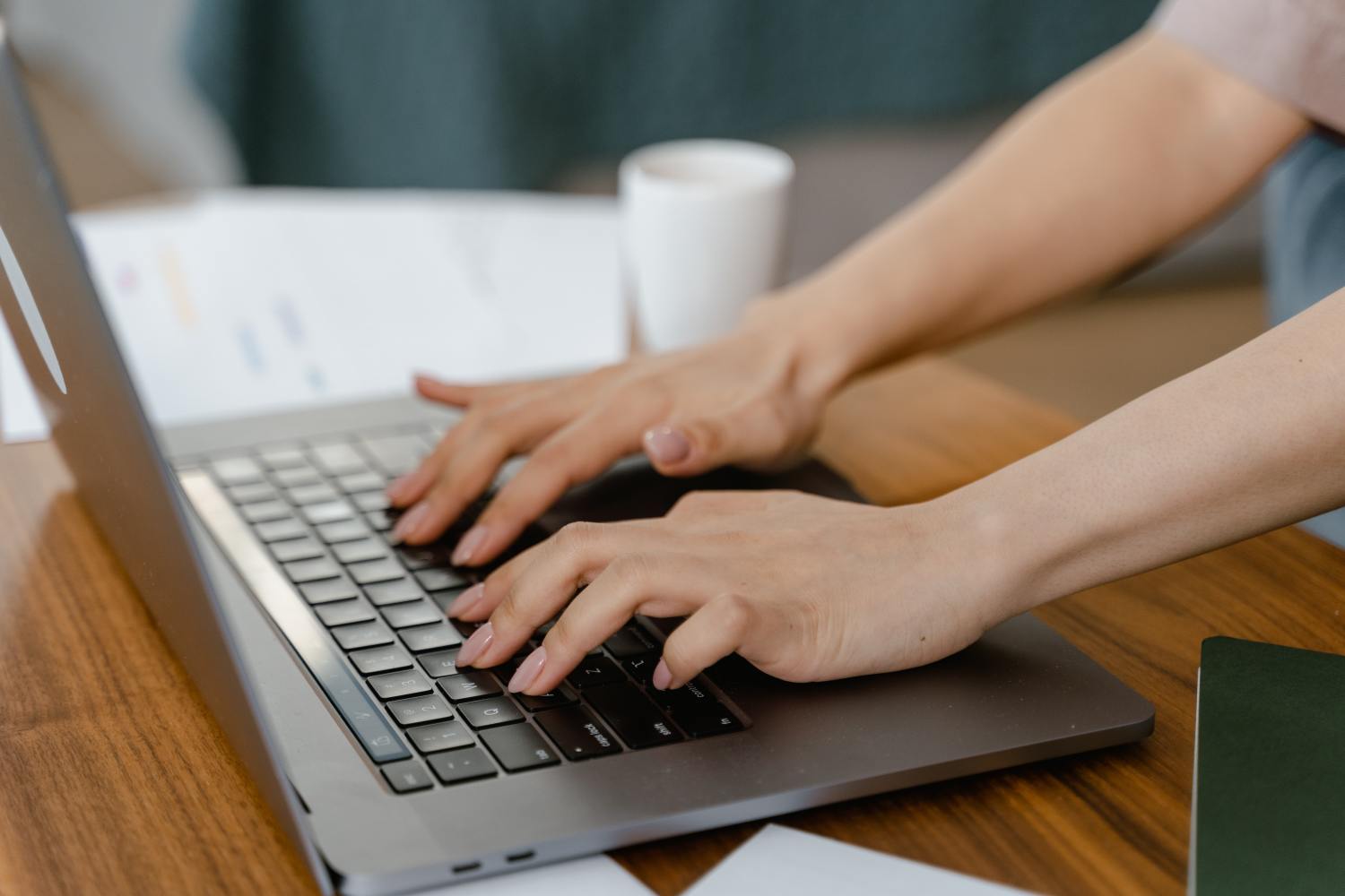Woman's hands typing on computer to research probate vs non probate assets.