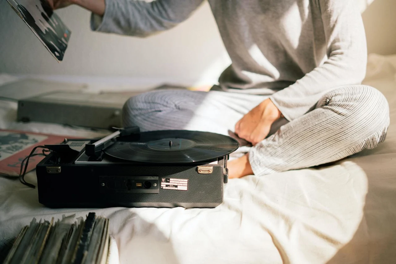 Woman listening to Elvis records after learning about the Elvis Presley estate battle.