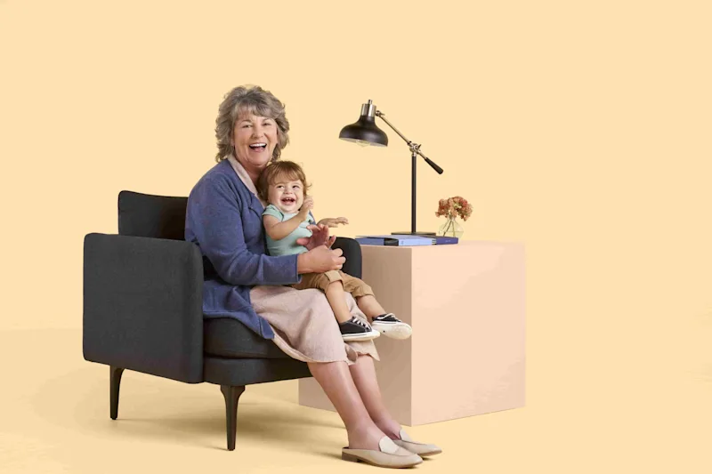 grandmother holding grandchild laughing 