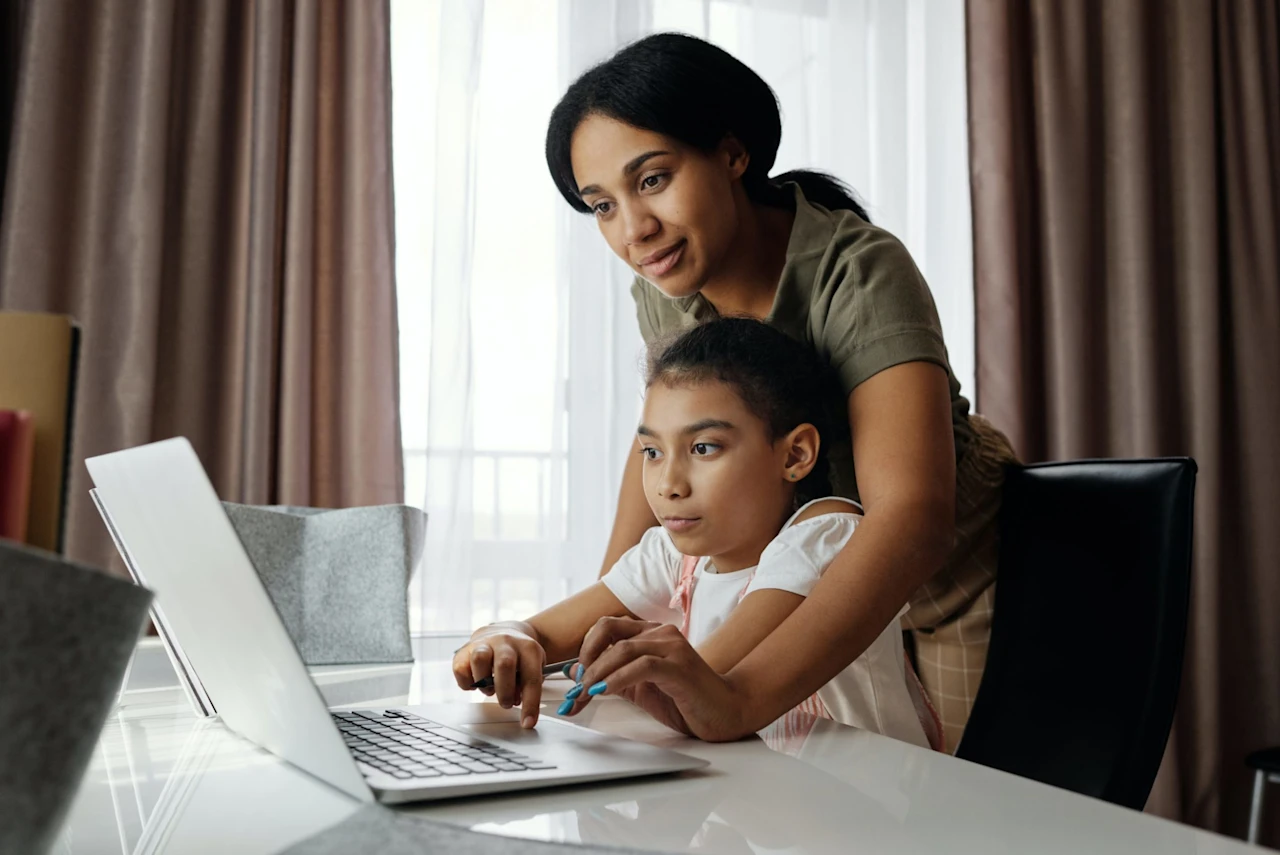 Mother showing her kids online how to fund a trust. 