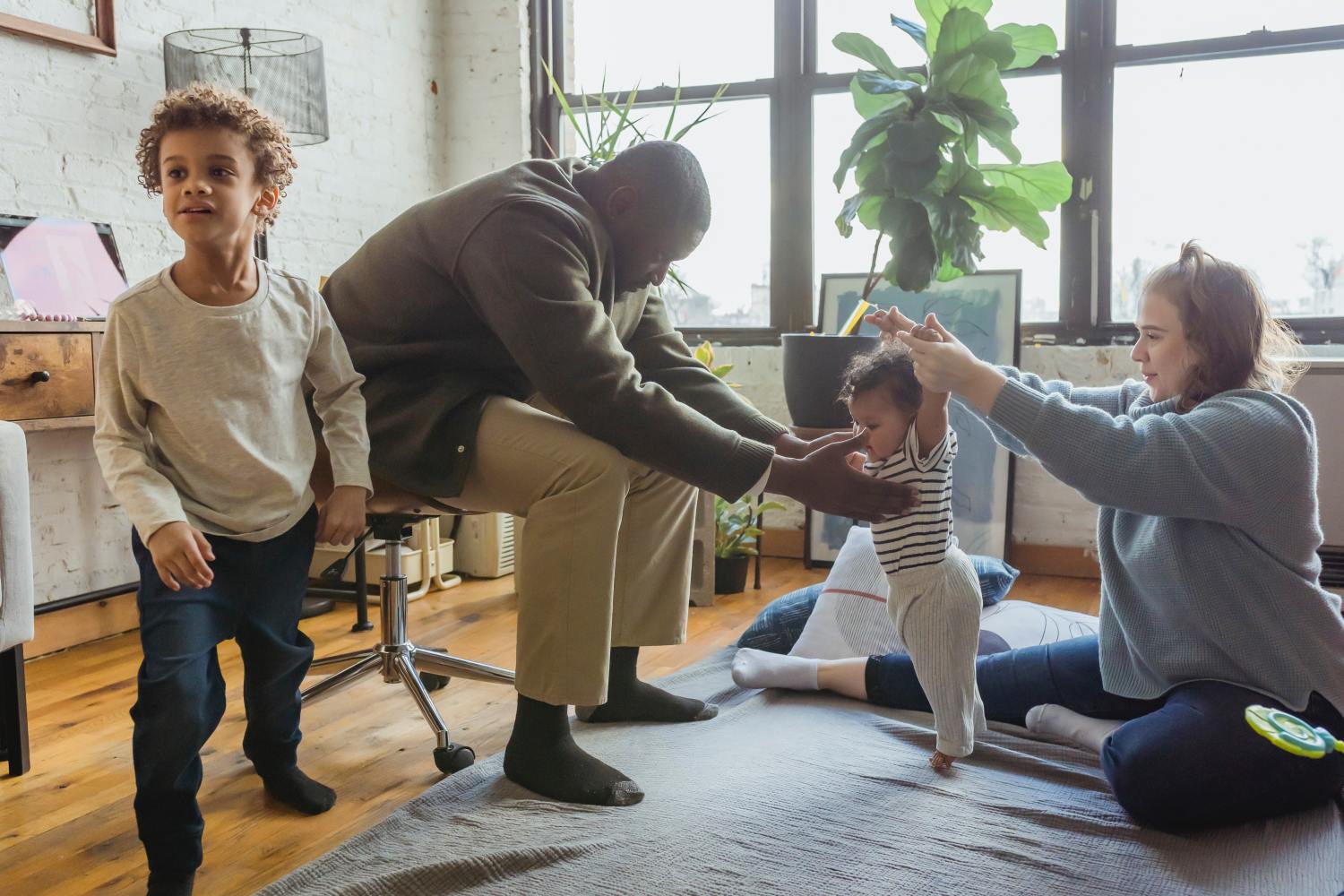 Couple playing with kids after learning everything they need to know about filial responsibility.