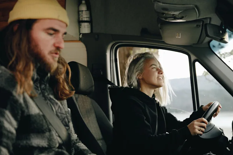 Couple driving in car, talking about spousal property petition guide.