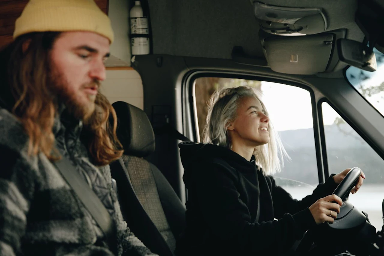 Couple driving in car, talking about spousal property petition guide.