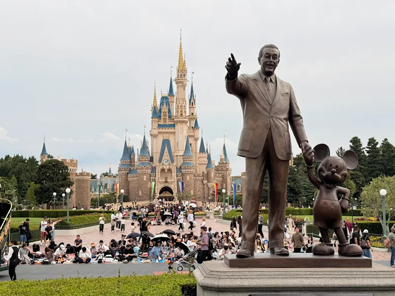 Partners statue of Walt Disney holding Mickey Mouse's hand in front of Cinderella Castle at Disneyland