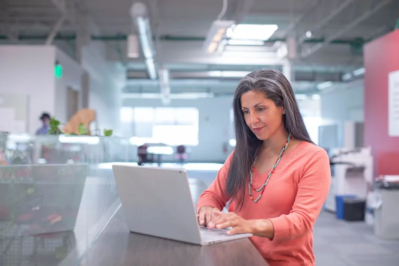 Woman on laptop researching succession planning for small businesses.