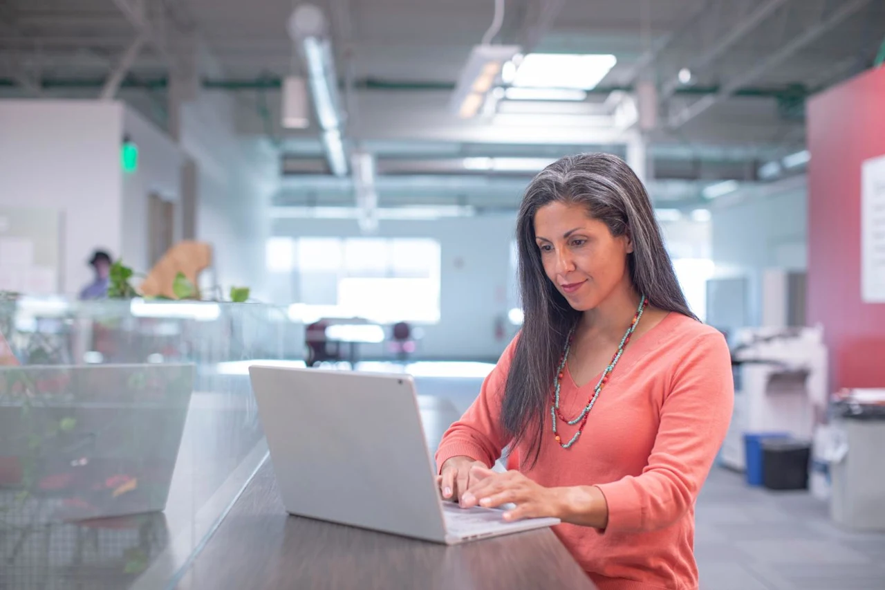 Woman on laptop researching succession planning for small businesses.