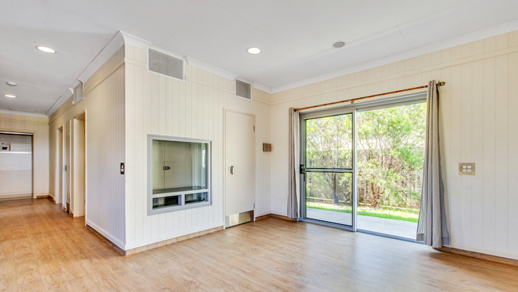 --Lounge area and hallway. Wooden floors and sliding window doors.--