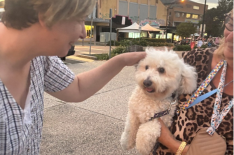 Nicolette meeting and petting a white dog.