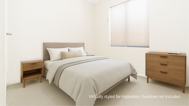 Bedroom with beige walls, modern wooden bed frame, matching bedside table and dresser, and window with beige blinds.