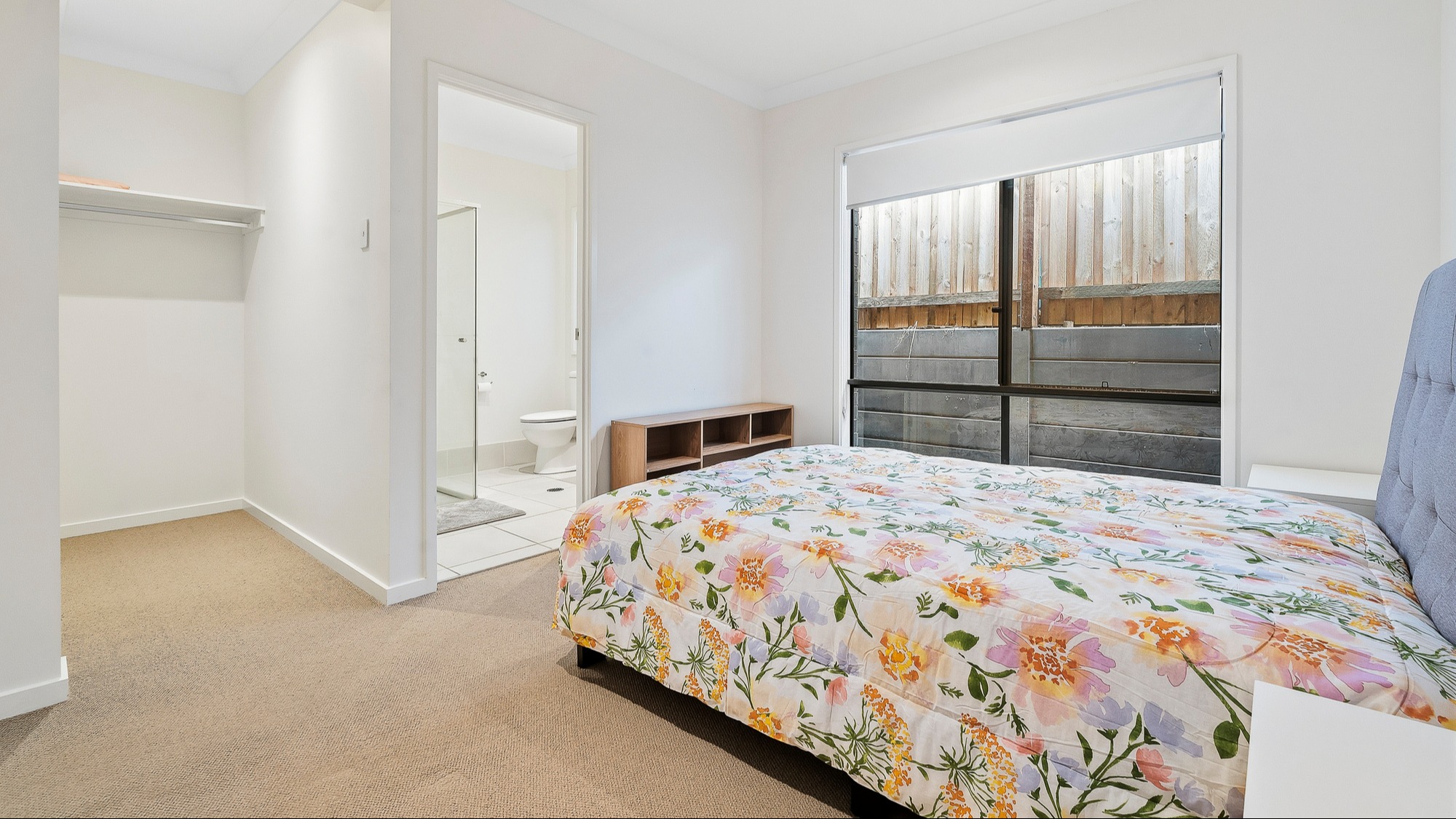 Master bedroom with double bed, ceiling fan, walk-in wardrobe and access to a private ensuite.