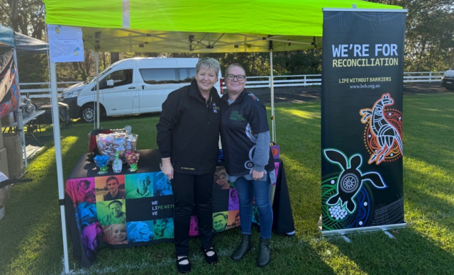 Two staff members at a Life Without Barriers stall.