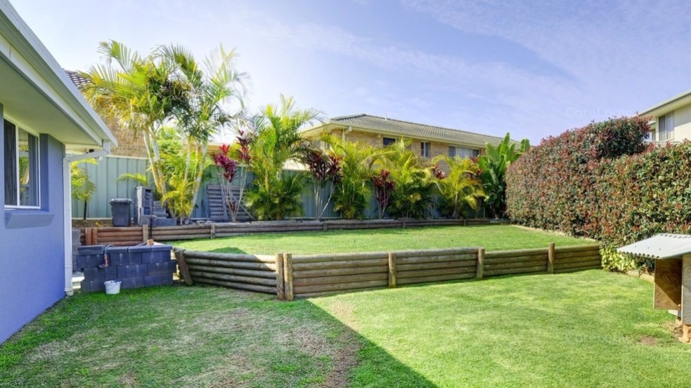 Back yard with grass and two levels.