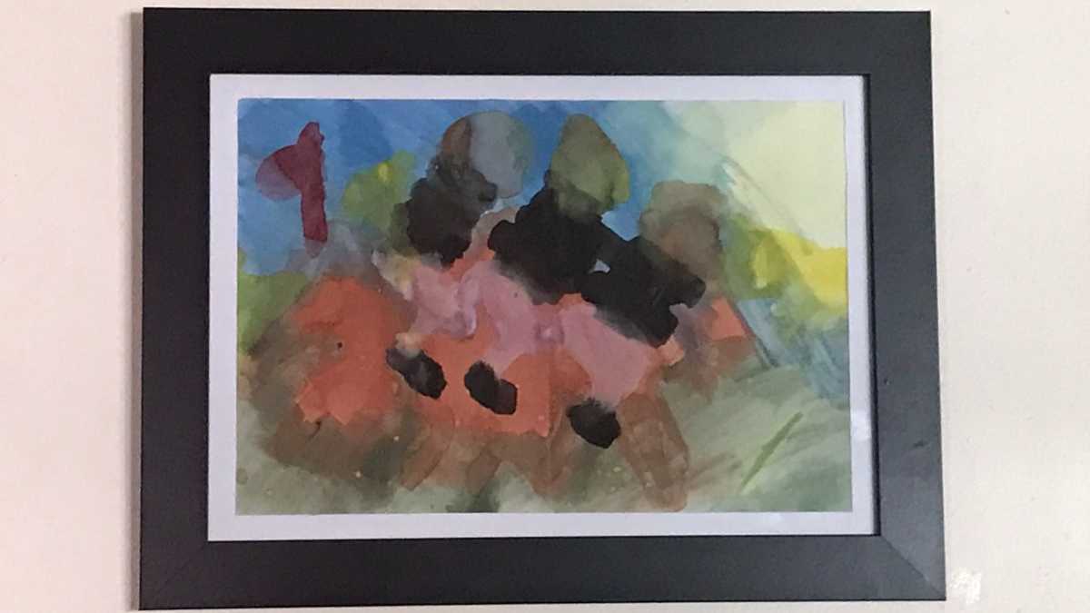 Emily's watercolour painting in a black frame.