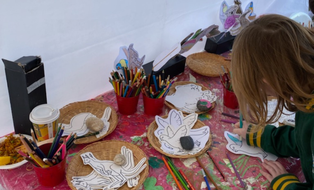 A child engaging in an activity at a Life Without Barriers stall.