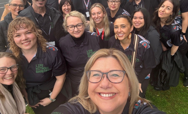 A large group of staff gather for a group selfie at the Awabakal Community NAIDOC March.