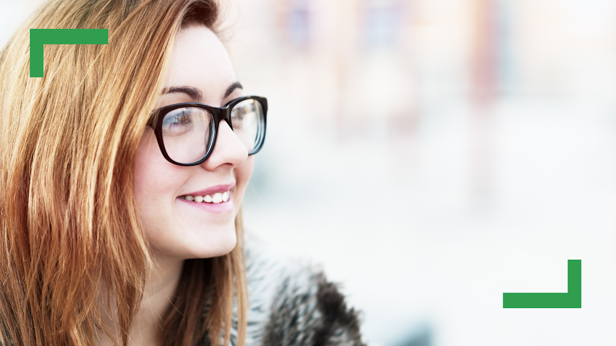 Close up of a teenage girl with sandy blonde hair wearing glasses.