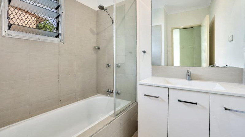 --Bathroom with shower over bath.--