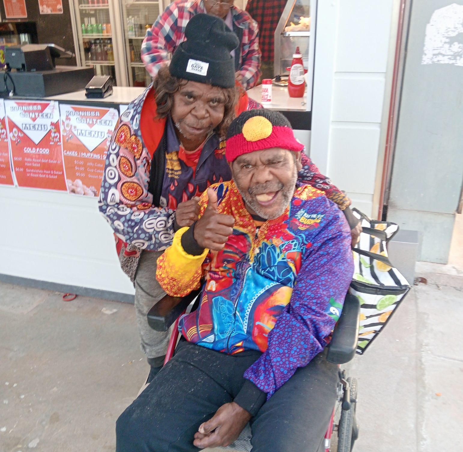 Two participants at the Ceduna NAIDOC March, they are smiling at the camera and giving a thumbs up.