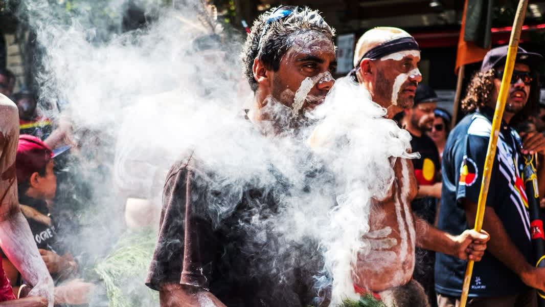 An Aboriginal protestor holds native Australian plants used for a smoking ceremony during a demonstration by Aboriginal rights activists in Melbourne, Australia, on January 26, 2018. Asanka Brendon Ratnayake/Anadolu Agency/Getty Images
