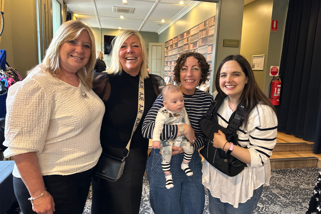 A group of staff and carers smiling at the camera.