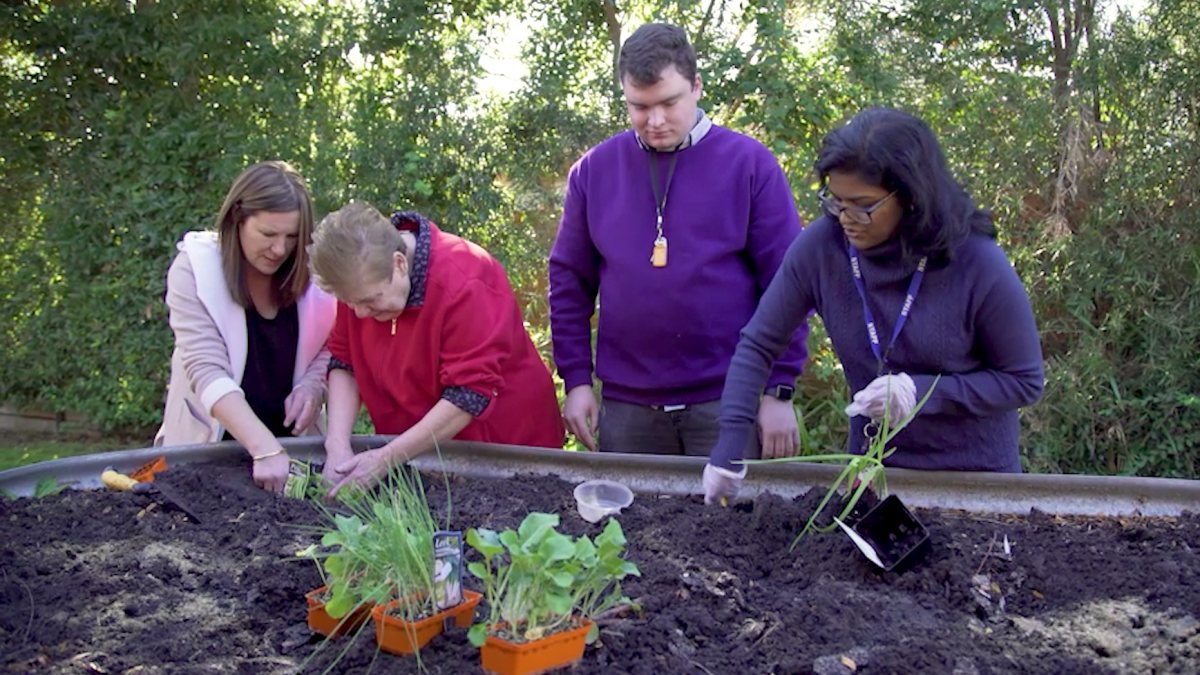 Staff and people we support at Devonshire Road planting a new garden bed.