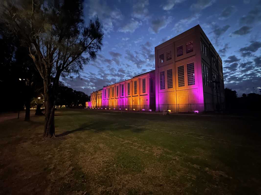 East Perth Power Station lit up in pink to promote Sharing is Caring.