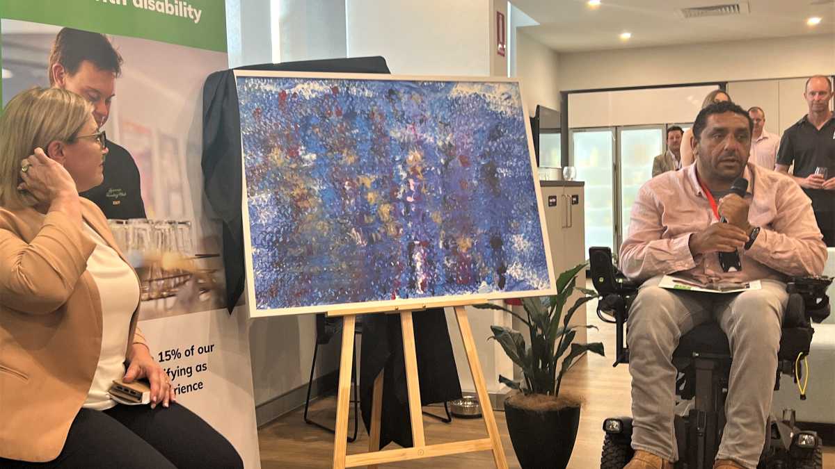 Dom delivering a speech at the AIEP launch, where his painting was revealed.