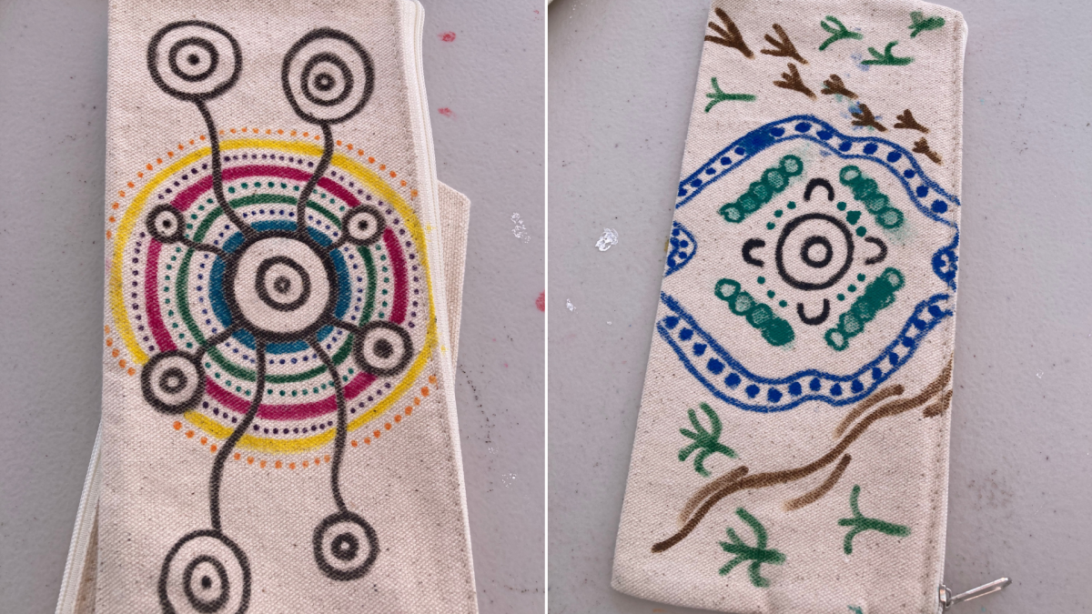 Two pencil cases with hand-drawn designs.