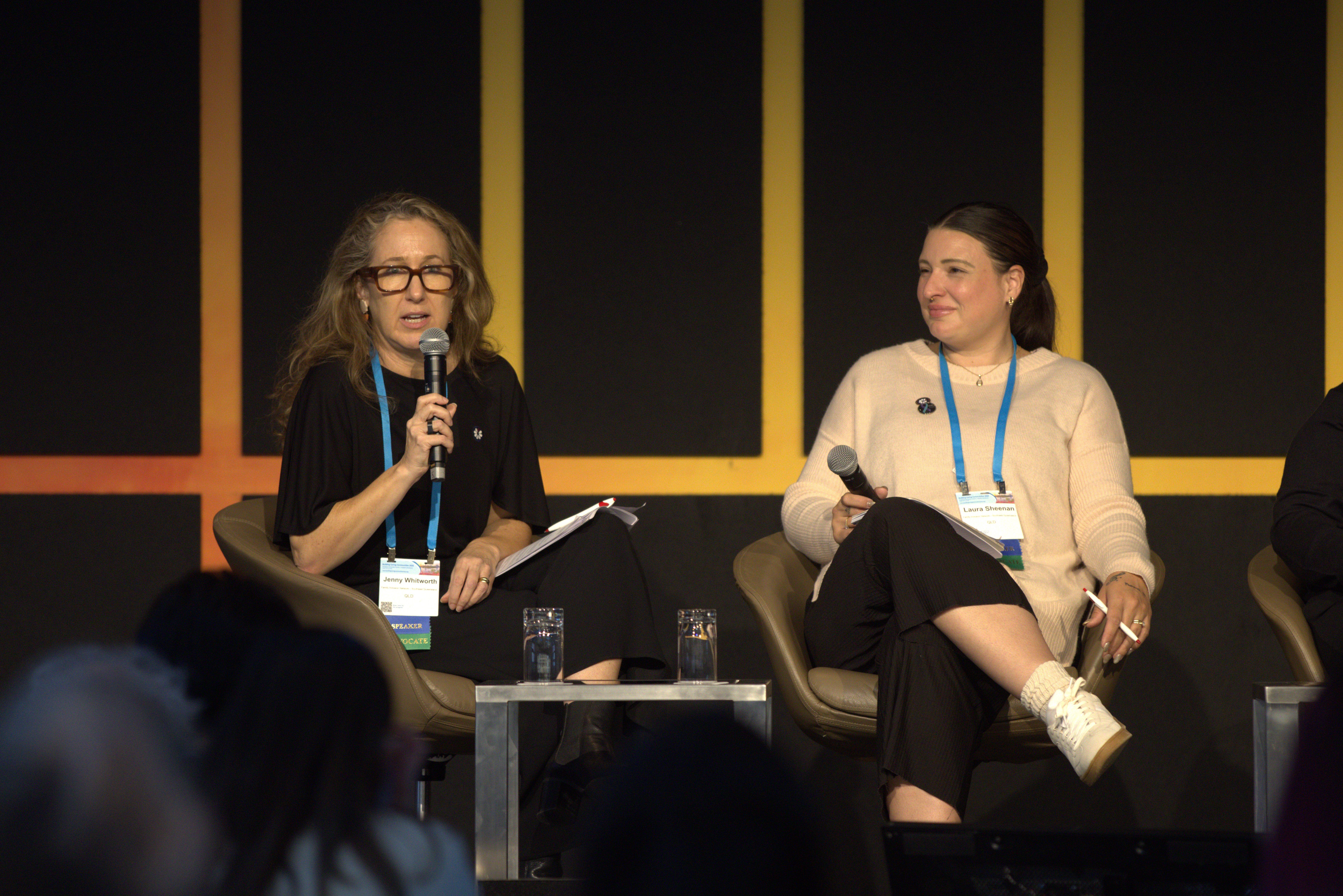 Jenny Whitworth, Program Coordinator and Laura Sheenan from the Family Inclusion Network – Southeast Queensland speak on stage.