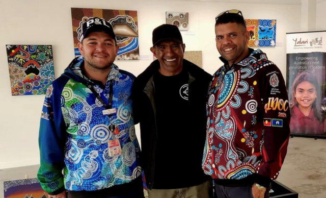Three people smiling at the camera at a Toowoomba NAIDOC Event.