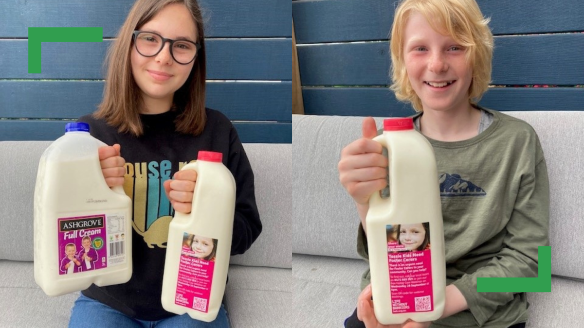 Two children holding milk cartons.