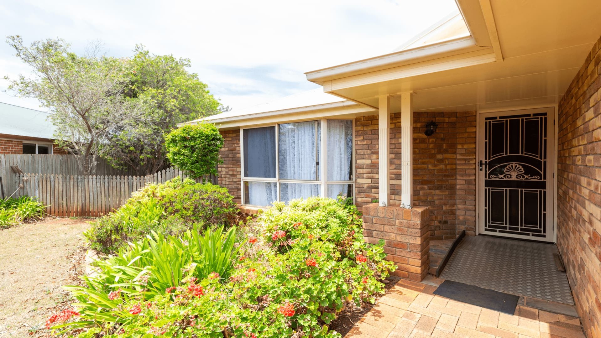 front entrance to red brick, single level home.