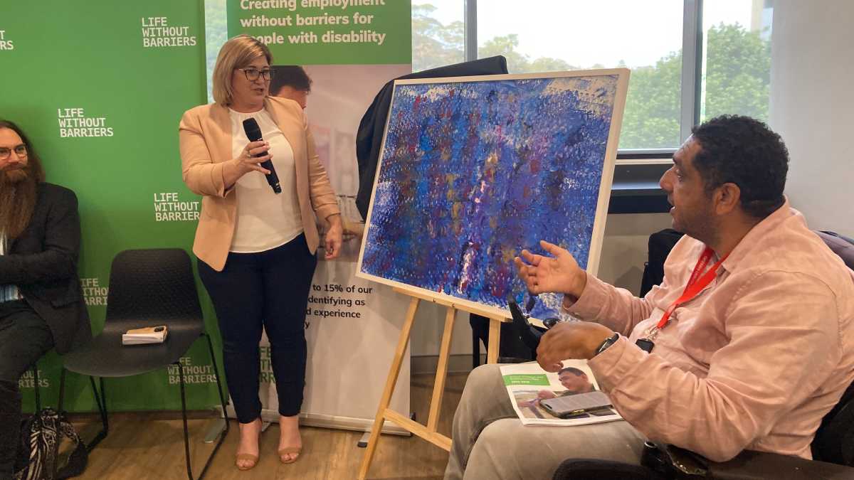 Claire Robbs and Dominic Freestone at the AIEP launch, revealing Dominic's painting.