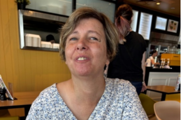 Nicolette enjoying a meal in a restaurant.