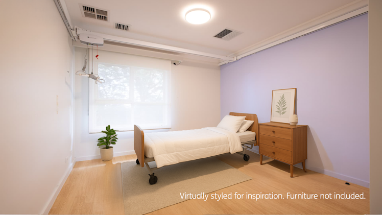 bedroom with pink painted feature wall large window and ceiling hoist.
