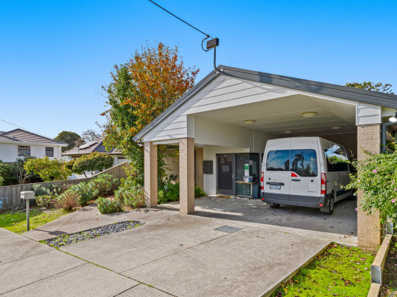 Front entrance to house, concrete driveway, undercover carport