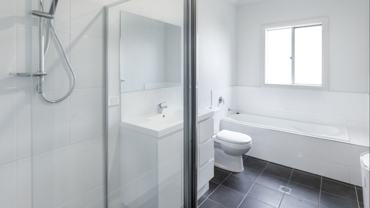 Bright white bathroom with a shower and bath.