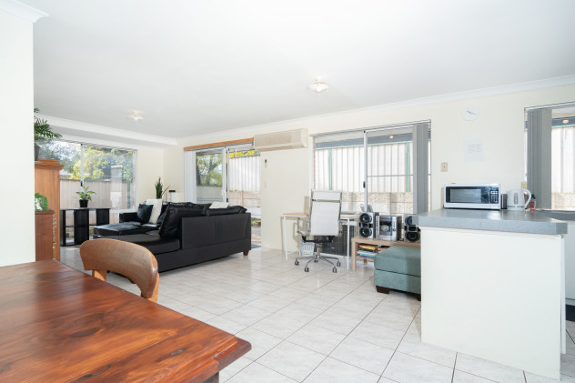 Open plan loungeroom with TV, dining and kitchen space