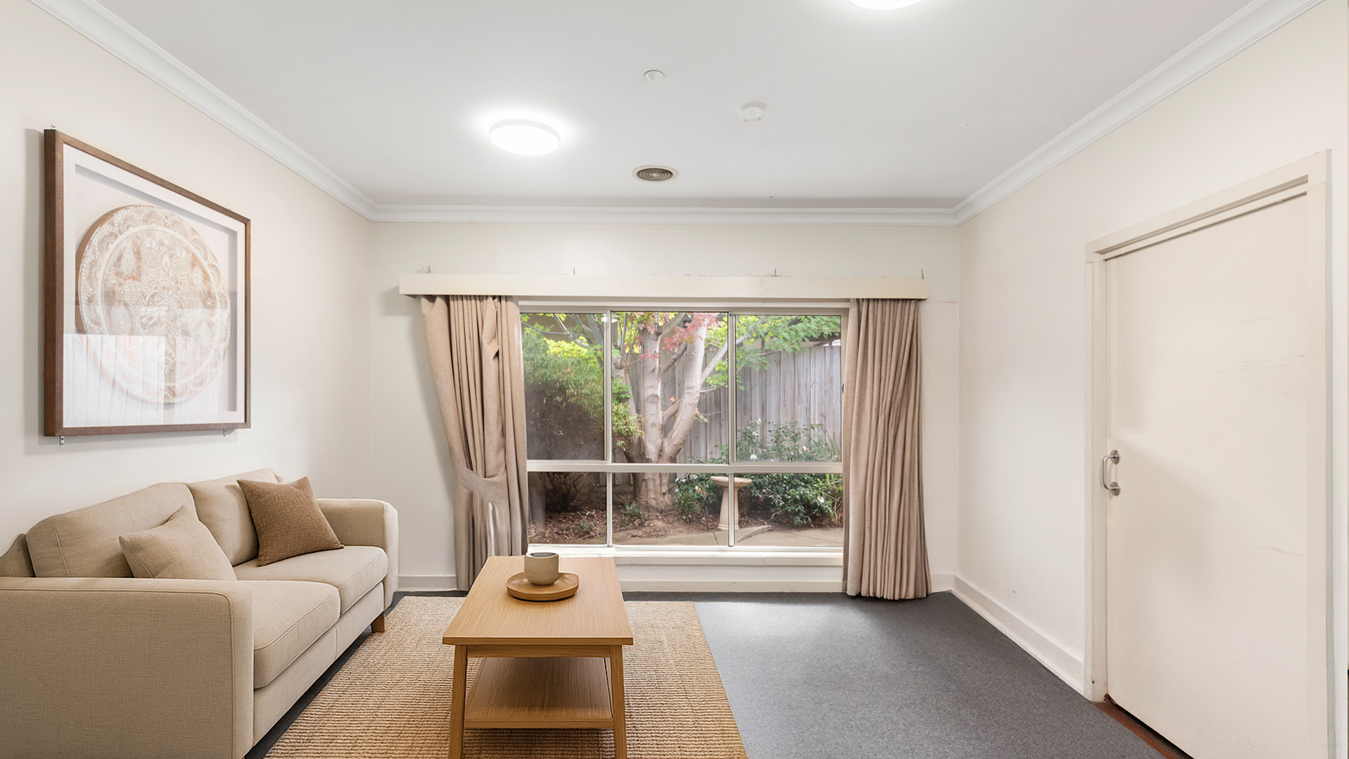 --Living room with two couches, an arm chair, a TV and a small table and chairs--