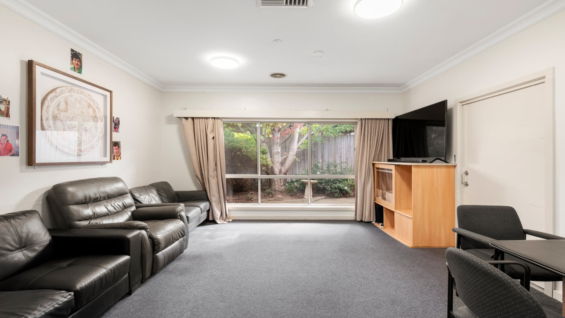 --Living room with two couches, an arm chair, a TV and a small table and chairs--