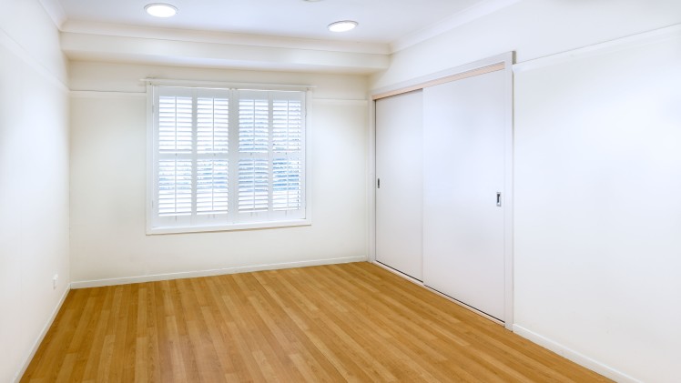 Bedroom with wooden floors and white walls, BIR, window. 