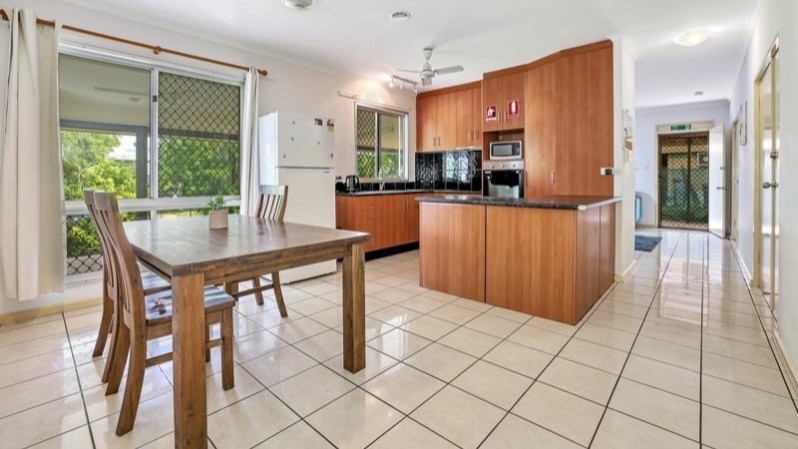 --Large wrap around kitchen and dining area. White tiled floor.--