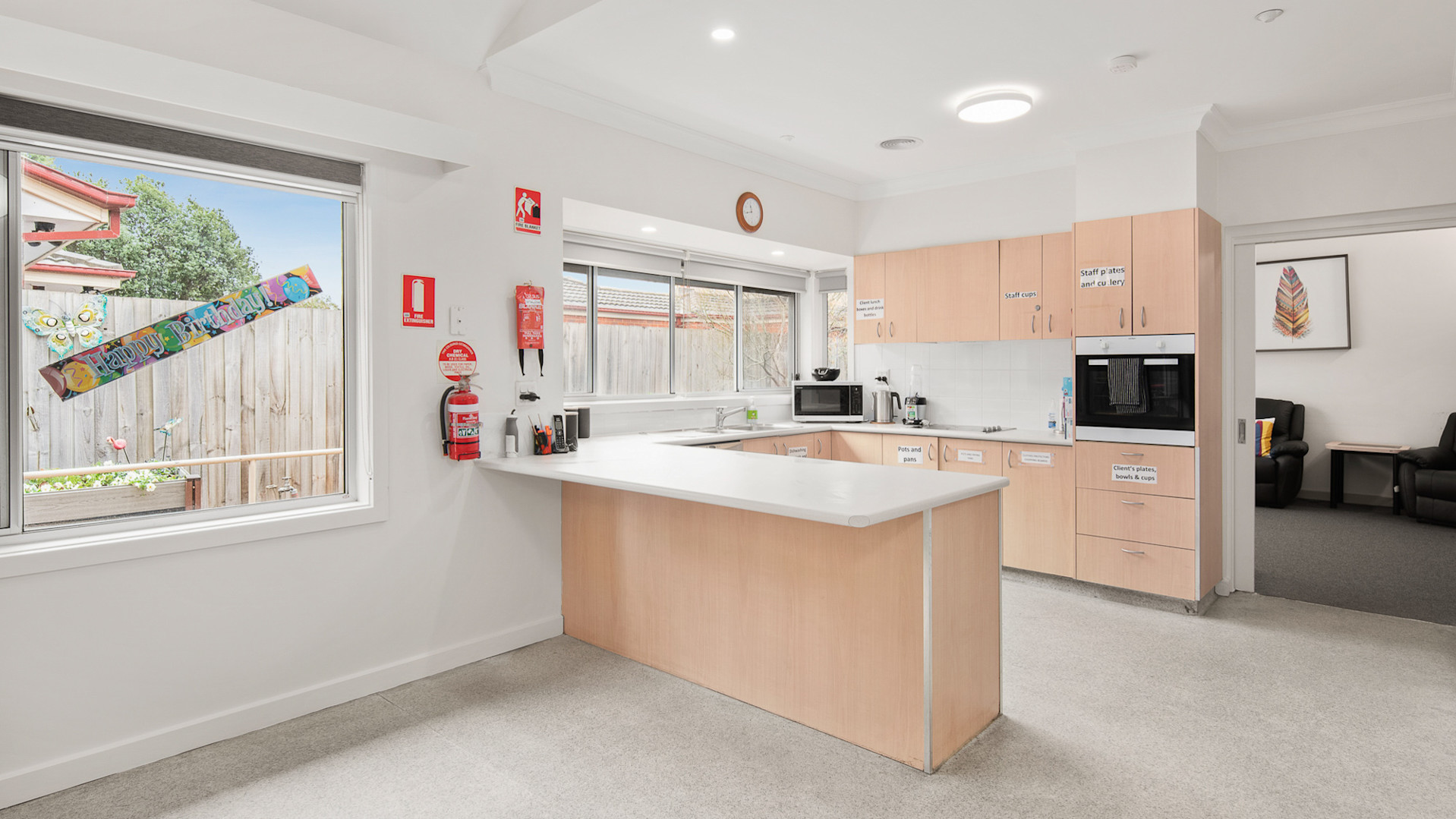 --Kitchen with light brown cabinets, microwave and oven.--