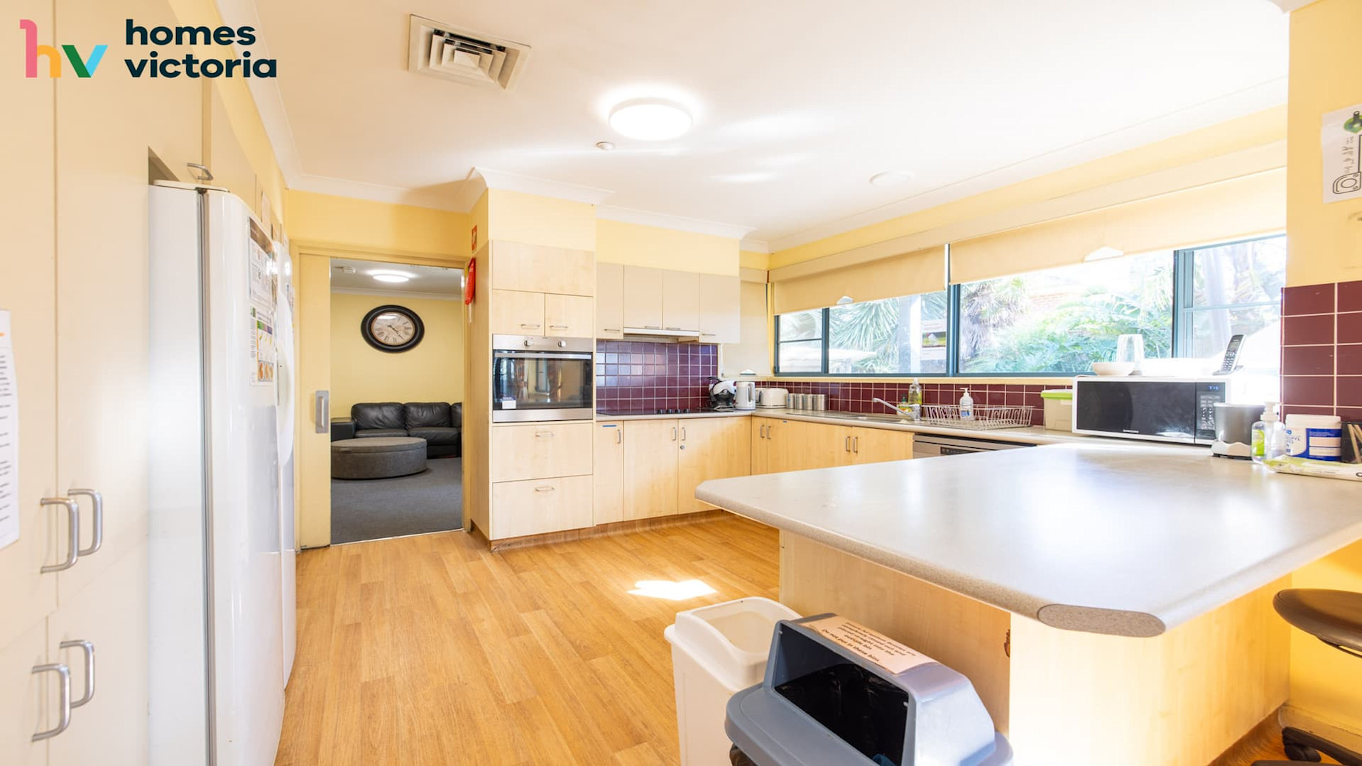 Spacious kitchen, hard wood flooring and windows.