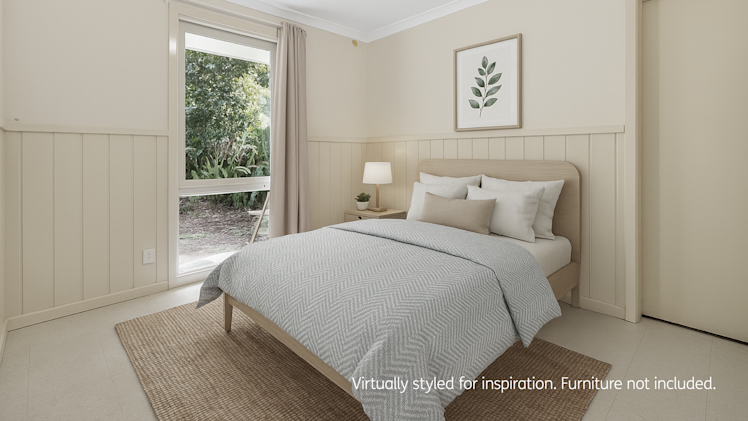 Bright and cozy bedroom with neutral tones, a light wood bed, textured grey bedding, natural fiber rug, and a large window overlooking a garden.