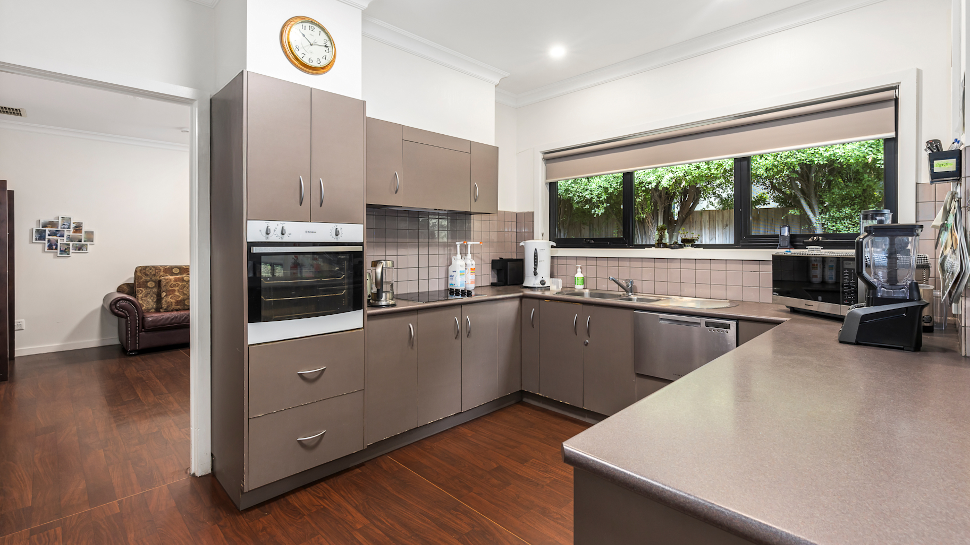 Kitchen with a u-shaped bench and ample storage.
