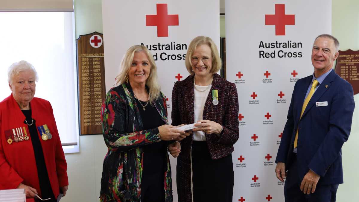Narelle (left) being presented with the National Emergency Medal by Governor-General, the Honourable Janette Young.