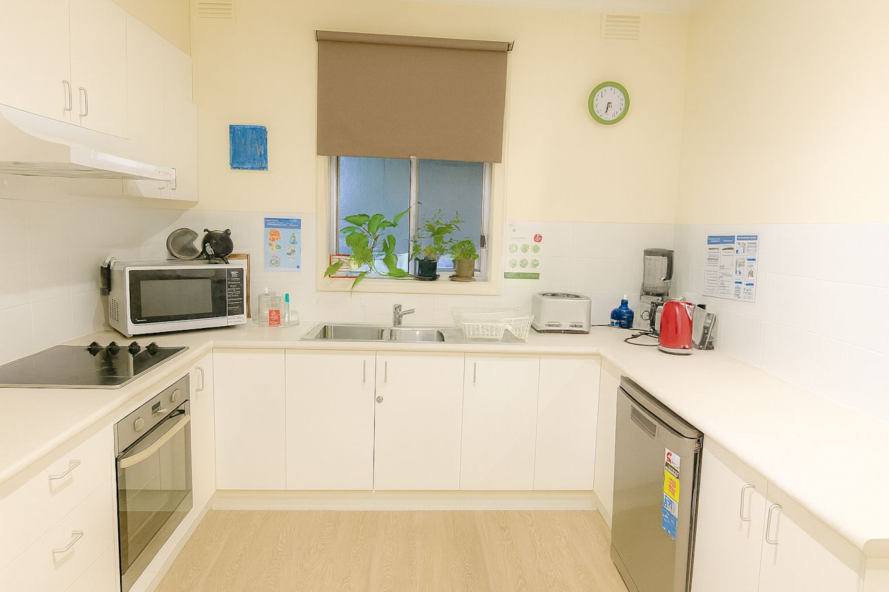 Hampton kitchen. White cabinets, wrap around, wooden floors. Oven and dishwasher.
