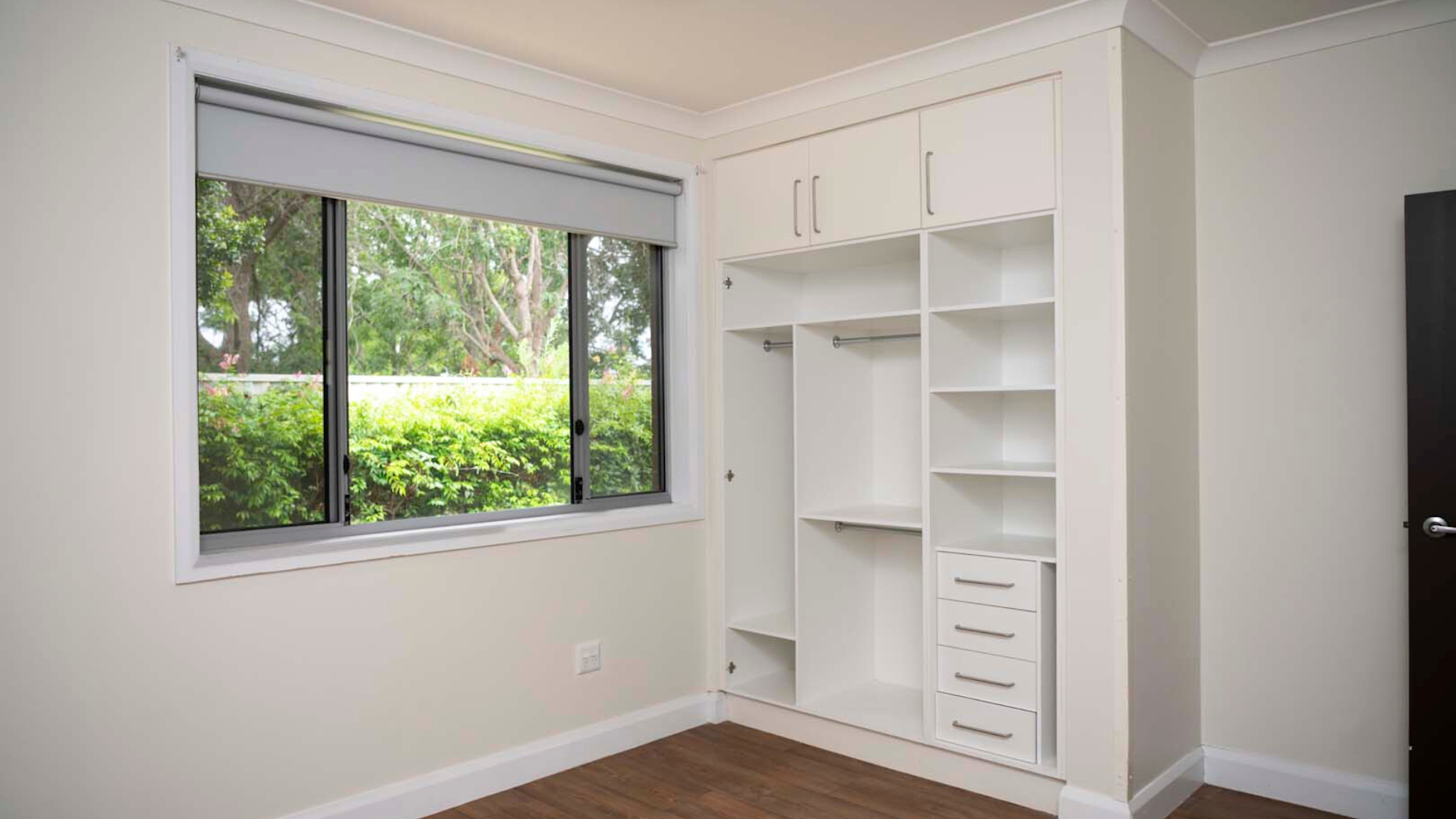 Bedroom with an open built-in wardrobe.